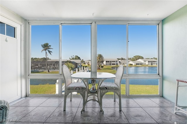 sunroom / solarium with a water view