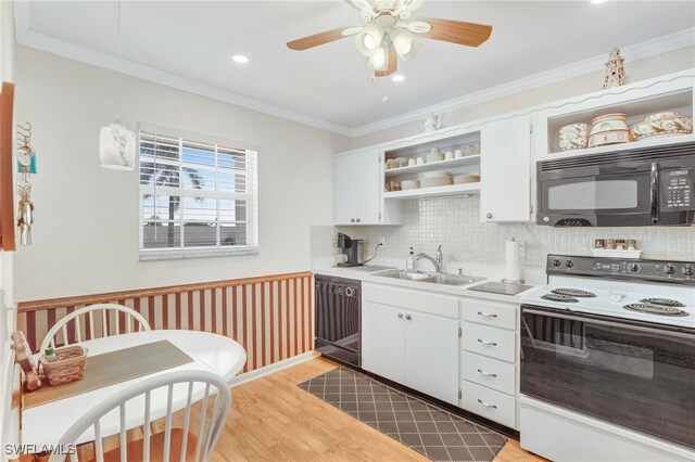 kitchen featuring open shelves, light wood-style flooring, ornamental molding, a sink, and black appliances