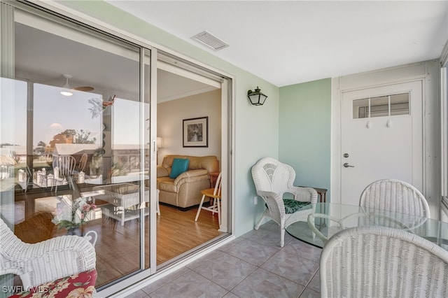 sunroom featuring ceiling fan and visible vents