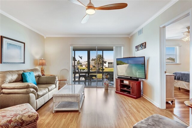 living area featuring ceiling fan, wood finished floors, visible vents, and crown molding