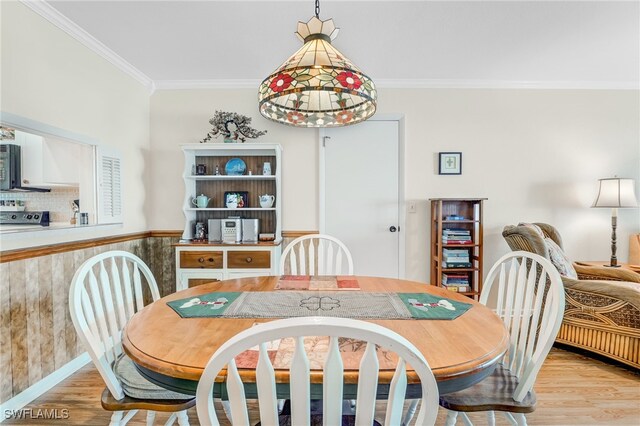 dining area featuring ornamental molding and light wood-type flooring