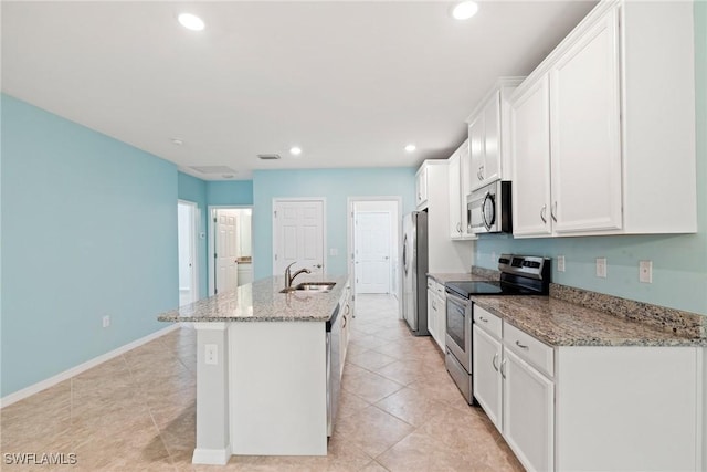 kitchen with recessed lighting, a sink, white cabinetry, appliances with stainless steel finishes, and an island with sink