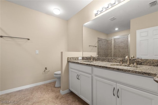 full bath with a tile shower, toilet, a sink, and visible vents