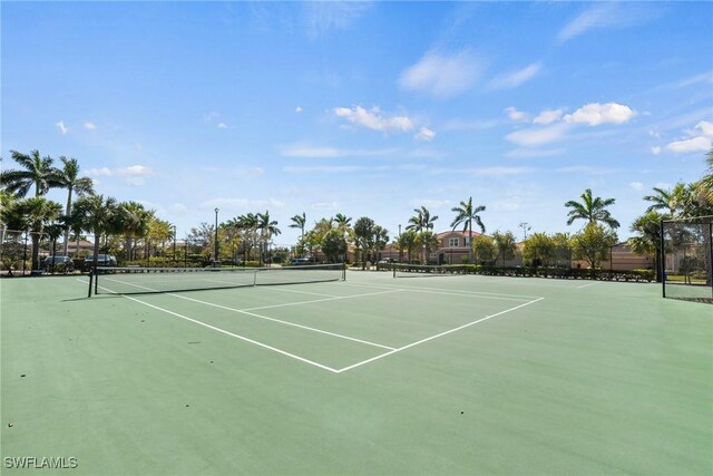 view of tennis court featuring fence