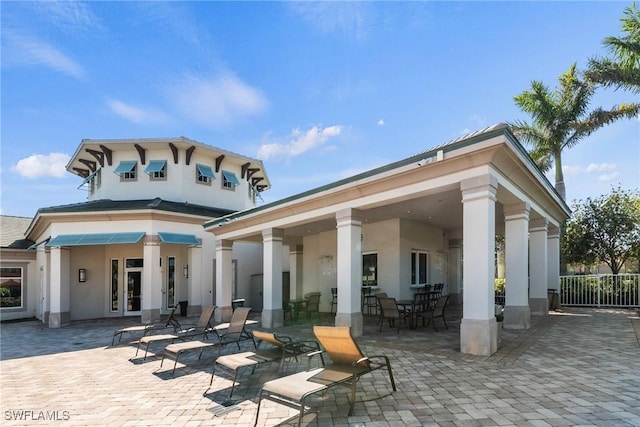 rear view of property featuring a patio and stucco siding