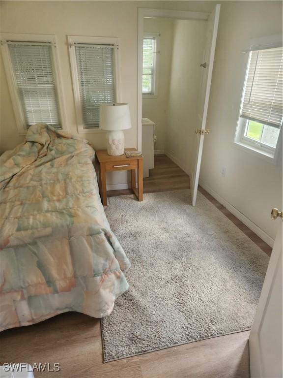 bedroom with multiple windows and baseboards