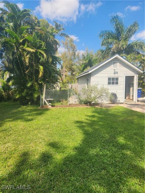 view of side of property featuring a yard and fence