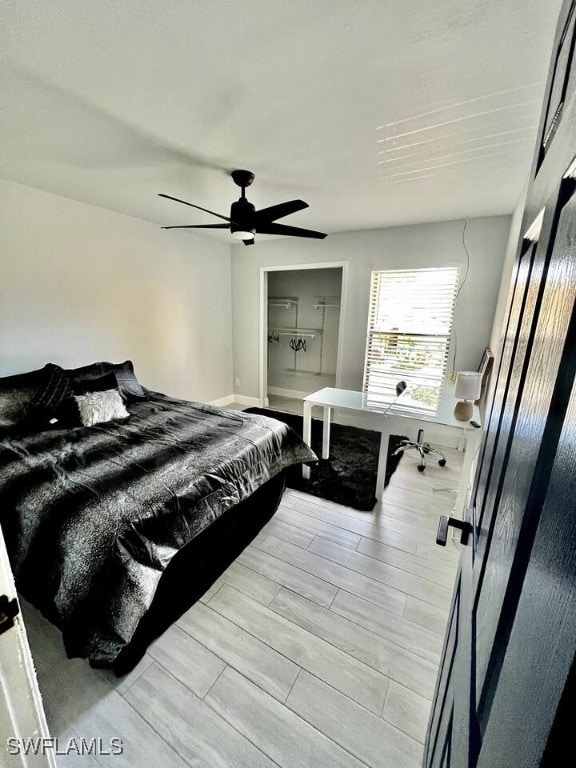 bedroom with a ceiling fan and wood finish floors