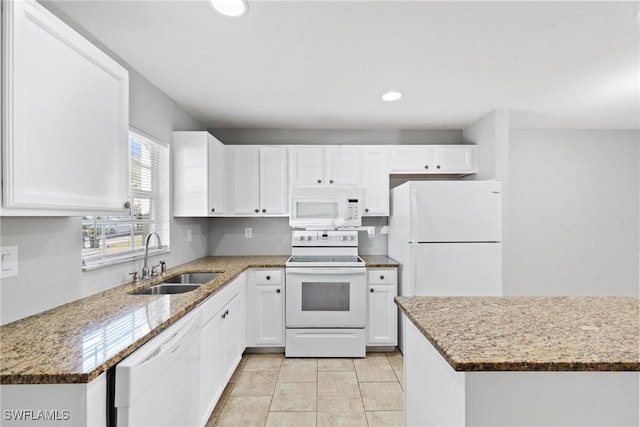 kitchen featuring a sink, white cabinetry, recessed lighting, white appliances, and light stone countertops