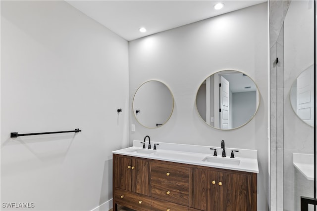 bathroom with recessed lighting, a sink, and double vanity