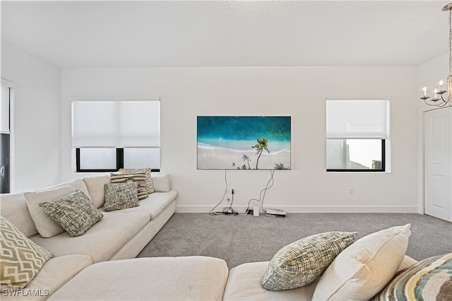 living area with a notable chandelier, baseboards, and carpet