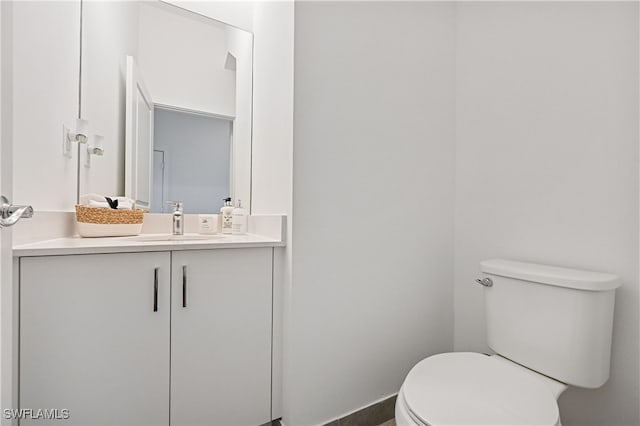 half bathroom with toilet and vanity