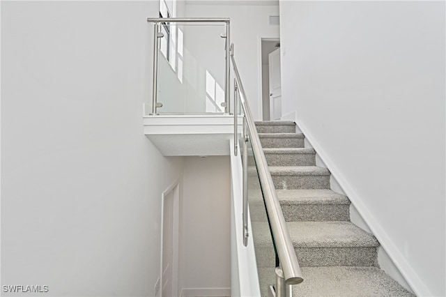 staircase featuring visible vents and baseboards