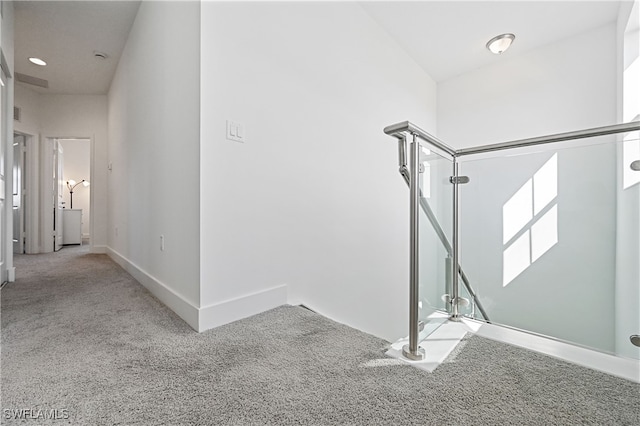 staircase featuring carpet flooring and baseboards