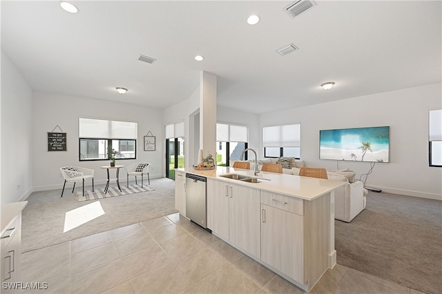 kitchen featuring visible vents, a sink, open floor plan, light colored carpet, and dishwasher