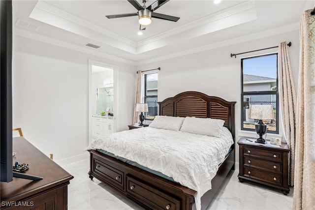 bedroom with visible vents, a tray ceiling, baseboards, and ornamental molding