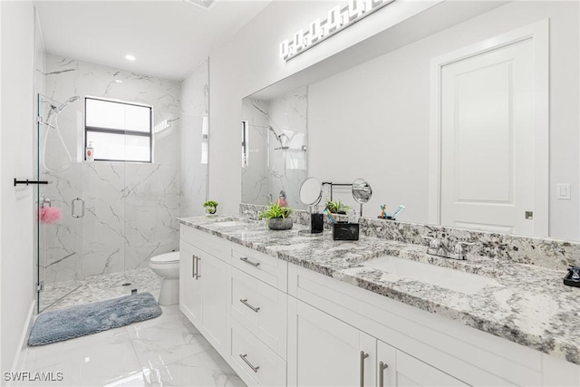 full bathroom featuring double vanity, a marble finish shower, toilet, marble finish floor, and a sink