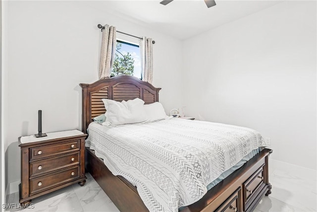 bedroom with a ceiling fan, marble finish floor, and baseboards