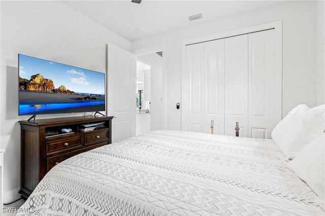 bedroom featuring visible vents and a closet