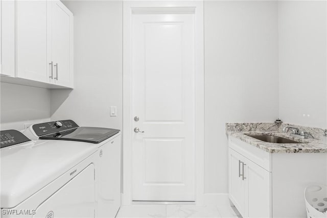 washroom with washer and dryer, marble finish floor, cabinet space, and a sink