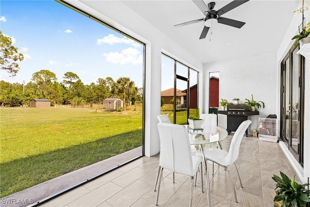 sunroom featuring a ceiling fan