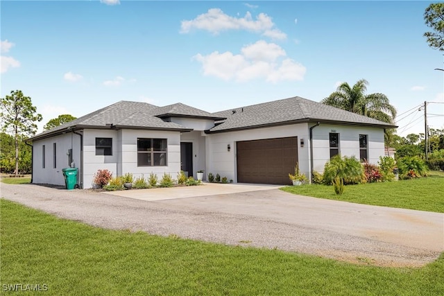 view of front of property with driveway, a garage, a shingled roof, a front yard, and stucco siding