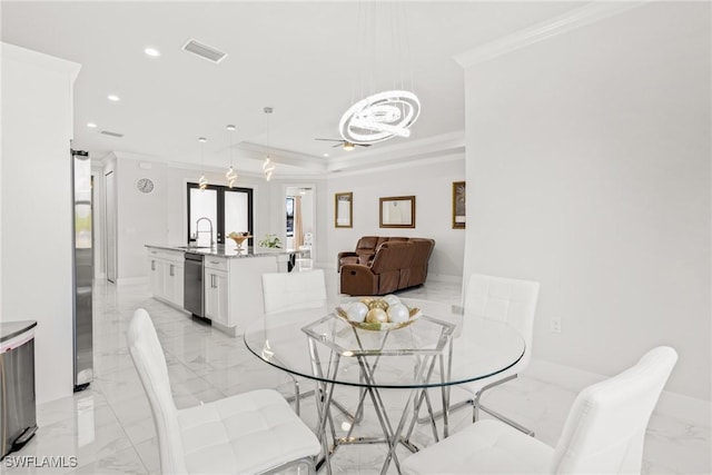 dining room with recessed lighting, marble finish floor, crown molding, and a tray ceiling