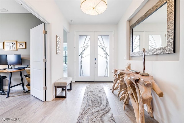 entryway with french doors, visible vents, and wood finished floors