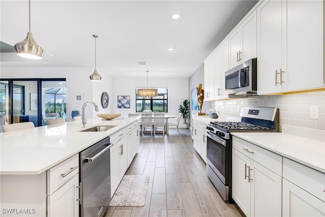 kitchen with light countertops, appliances with stainless steel finishes, and a sink