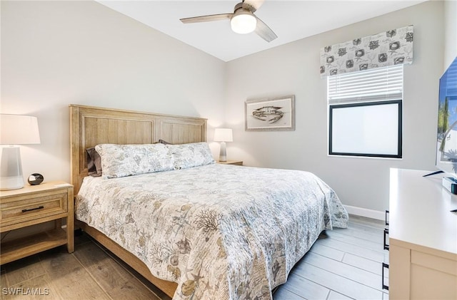 bedroom featuring light wood-type flooring, baseboards, and a ceiling fan