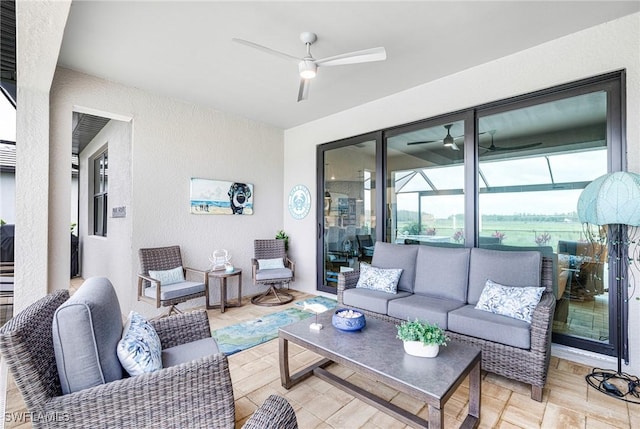 living room featuring a ceiling fan, a sunroom, and a textured wall