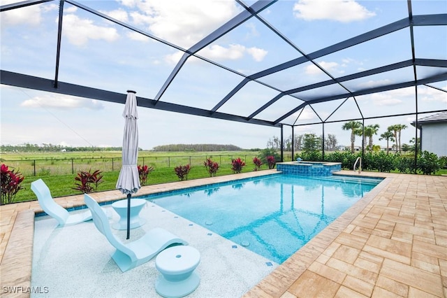 view of pool featuring a patio, glass enclosure, a rural view, fence, and a pool with connected hot tub