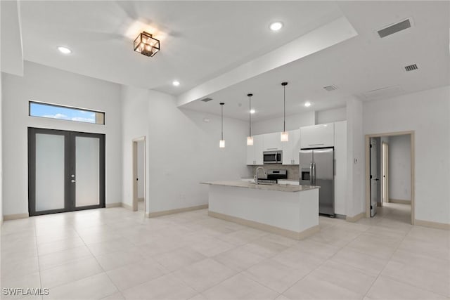 kitchen with visible vents, a sink, french doors, appliances with stainless steel finishes, and white cabinetry