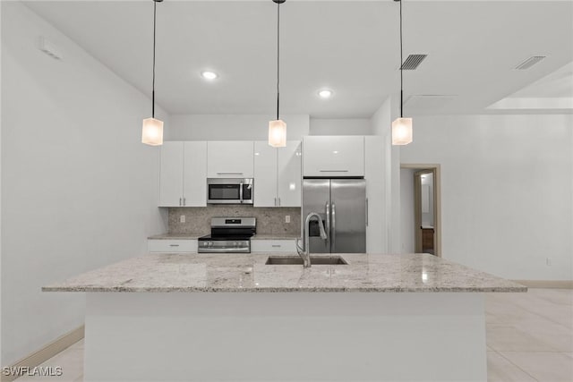 kitchen with a sink, decorative backsplash, appliances with stainless steel finishes, and white cabinetry