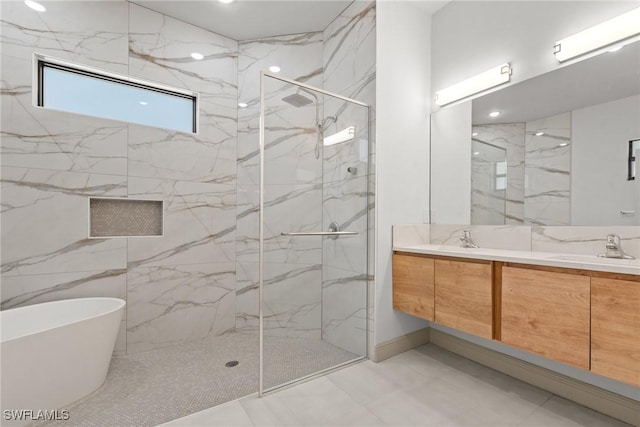 full bathroom with a sink, a marble finish shower, a freestanding bath, and double vanity