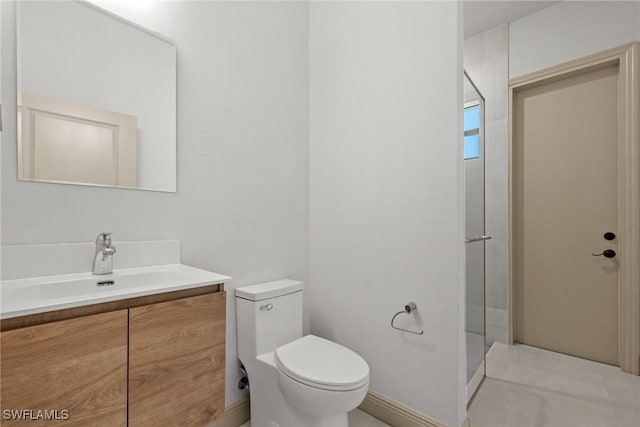 bathroom featuring vanity, toilet, and a walk in shower