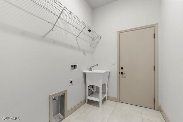 clothes washing area featuring hookup for a washing machine, baseboards, hookup for an electric dryer, laundry area, and light tile patterned flooring