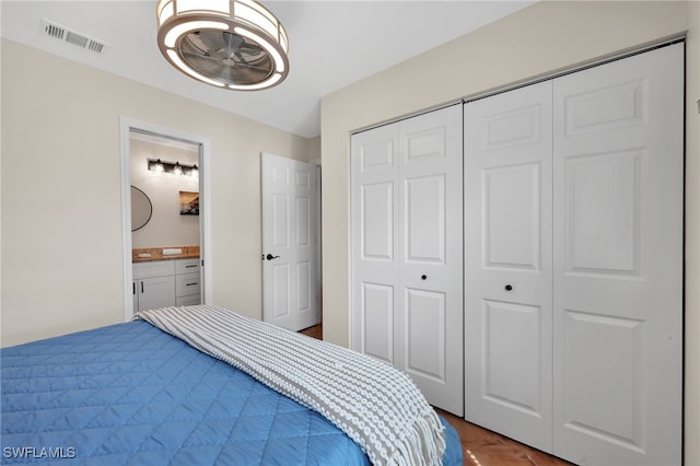 bedroom featuring a closet, ensuite bath, and visible vents