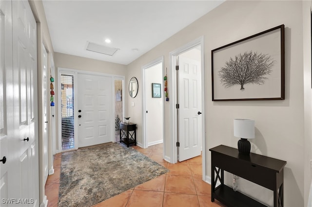 entrance foyer featuring light tile patterned flooring and baseboards