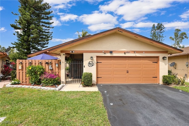 ranch-style home with aphalt driveway, stucco siding, a front yard, fence, and a garage