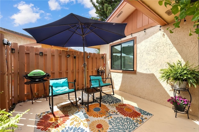 view of patio / terrace with grilling area and fence