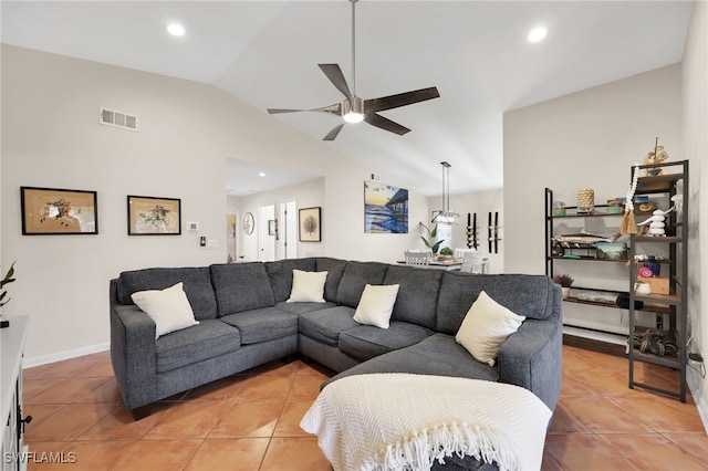 living room with light tile patterned floors, ceiling fan, visible vents, and vaulted ceiling