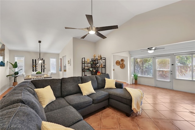 living room featuring ceiling fan, baseboards, and light tile patterned flooring