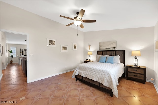 bedroom featuring baseboards and light tile patterned floors