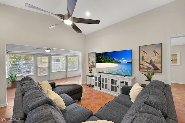 tiled living area with ceiling fan, high vaulted ceiling, and baseboards