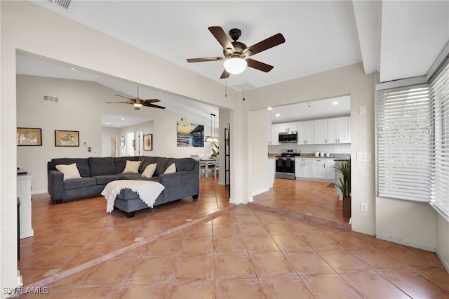 living room with light tile patterned floors, baseboards, visible vents, and vaulted ceiling