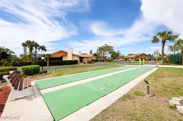 view of community featuring shuffleboard and a lawn