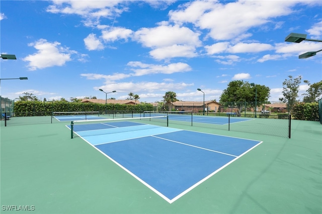 view of tennis court featuring fence