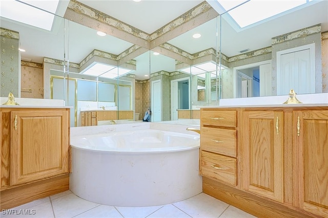 bathroom with tile patterned floors, a garden tub, a skylight, and wallpapered walls