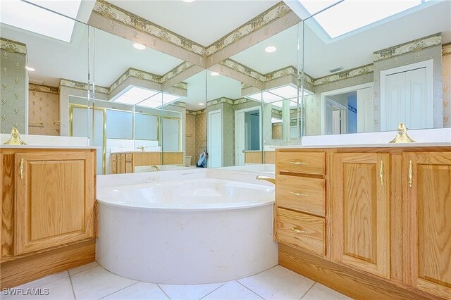 bathroom featuring wallpapered walls, tile patterned floors, a stall shower, a garden tub, and vanity